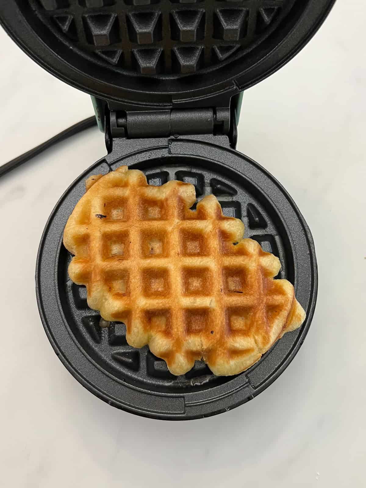 Cooked Croffle in waffle iron.